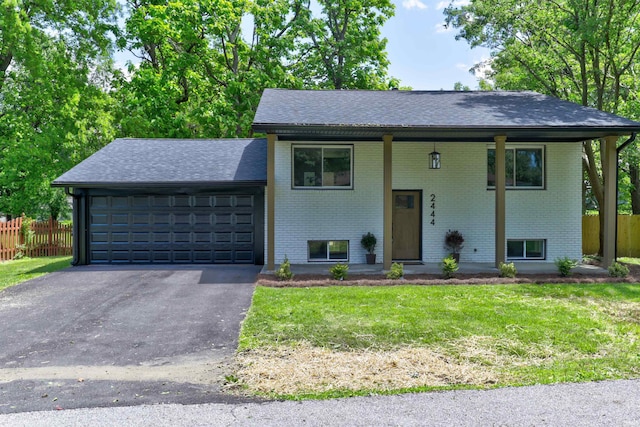 2444 Clover Cir, Newburgh, IN 47630 - bi-level home featuring brick siding, a garage, and roof with shingles
