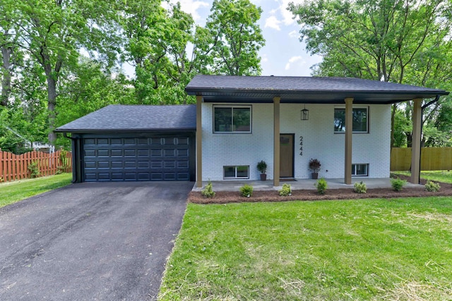 2444 Clover Cir, Newburgh, IN 47630 - bi-level home with brick siding, a porch, an attached garage, driveway, and roof with shingles