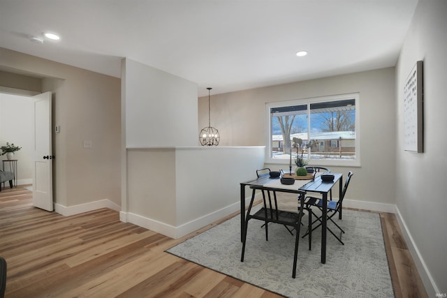 dining space with an inviting chandelier and hardwood / wood-style flooring