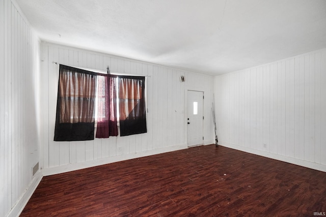 unfurnished room featuring plenty of natural light and hardwood / wood-style flooring