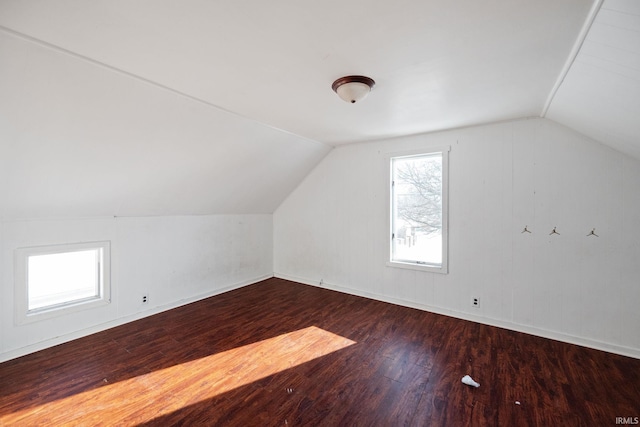 additional living space featuring dark hardwood / wood-style flooring and vaulted ceiling