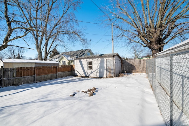 snowy yard with a shed