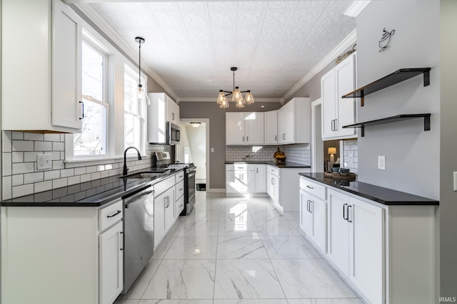 kitchen with hanging light fixtures, stainless steel appliances, crown molding, white cabinetry, and sink