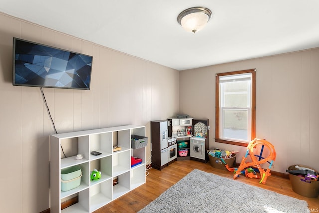 game room with light hardwood / wood-style floors