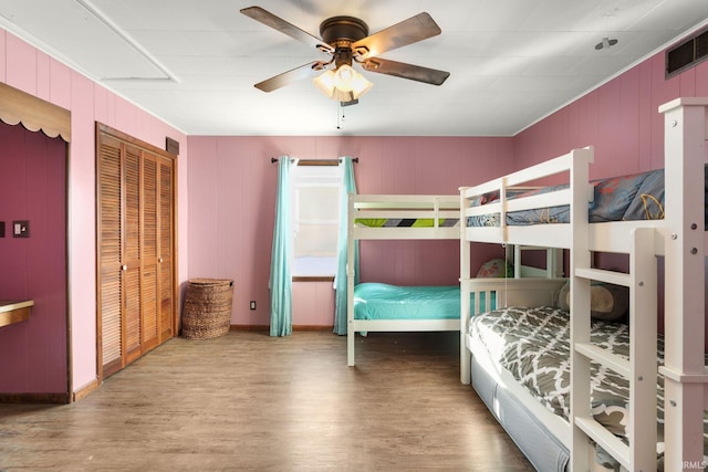 bedroom with a closet, ceiling fan, and hardwood / wood-style flooring