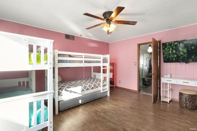 bedroom with ceiling fan and dark hardwood / wood-style floors