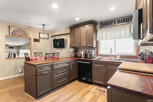 kitchen with decorative light fixtures, dishwasher, dark brown cabinets, and sink