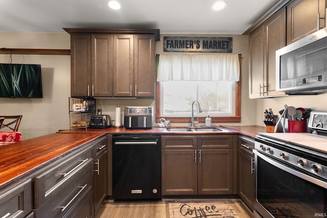 kitchen with range, dishwasher, dark brown cabinets, and sink