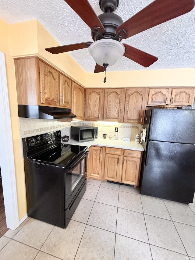 kitchen with black appliances, ceiling fan, light tile patterned flooring, a textured ceiling, and backsplash