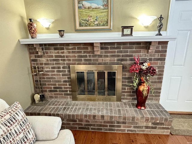 room details featuring a brick fireplace and hardwood / wood-style floors