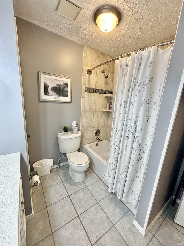 full bathroom with toilet, tile patterned floors, a textured ceiling, and shower / bath combo with shower curtain