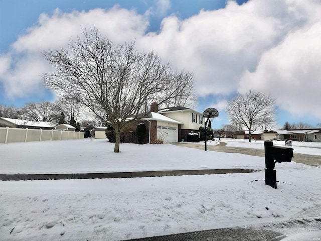 snowy yard with a garage