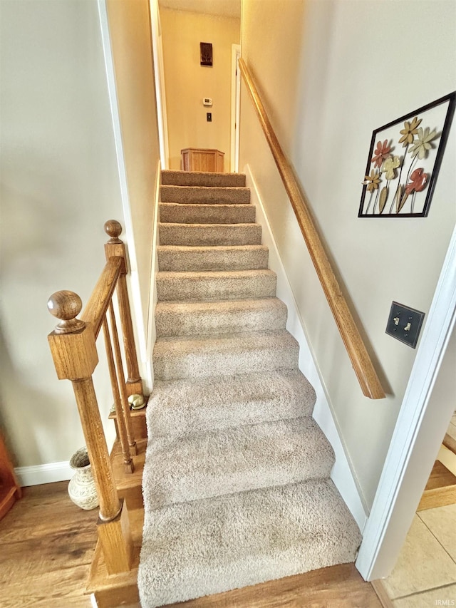 stairway featuring wood-type flooring