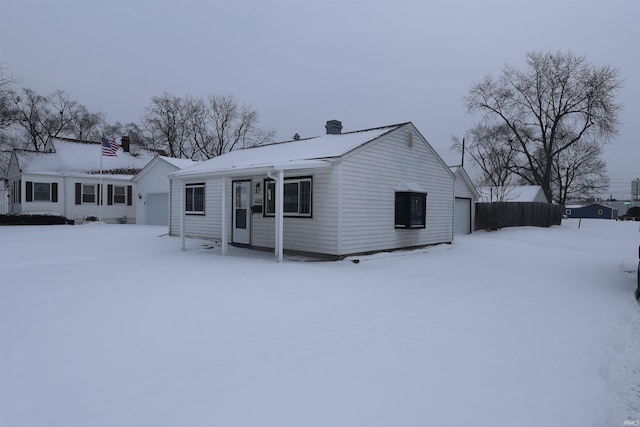 snow covered property with a garage