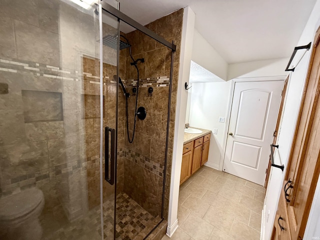 bathroom with toilet, a shower with door, and vanity