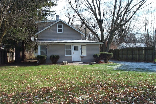 rear view of house with a yard