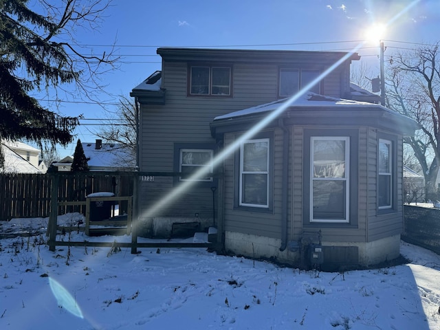 view of snow covered rear of property