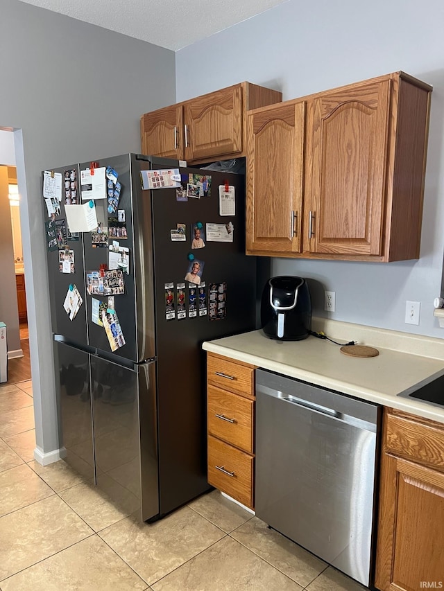 kitchen featuring light tile patterned floors and appliances with stainless steel finishes