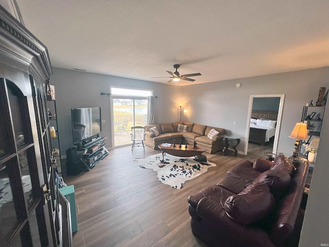 living room featuring ceiling fan and hardwood / wood-style floors