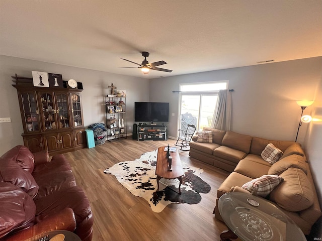 living room featuring ceiling fan and hardwood / wood-style floors