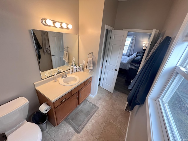 bathroom with vanity, tile patterned flooring, and toilet