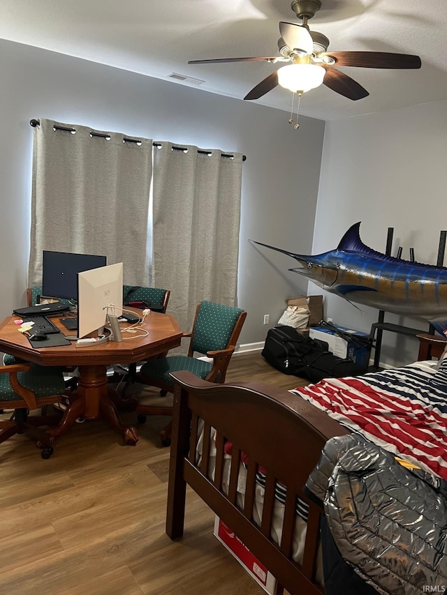 bedroom featuring hardwood / wood-style flooring and ceiling fan