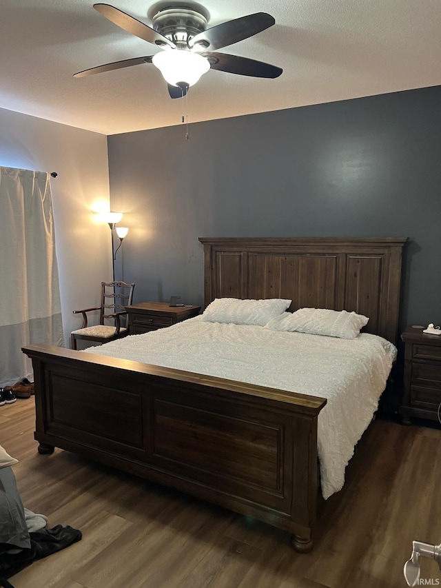 bedroom with dark wood-type flooring and ceiling fan