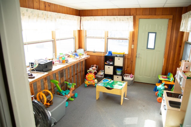 game room with wood walls