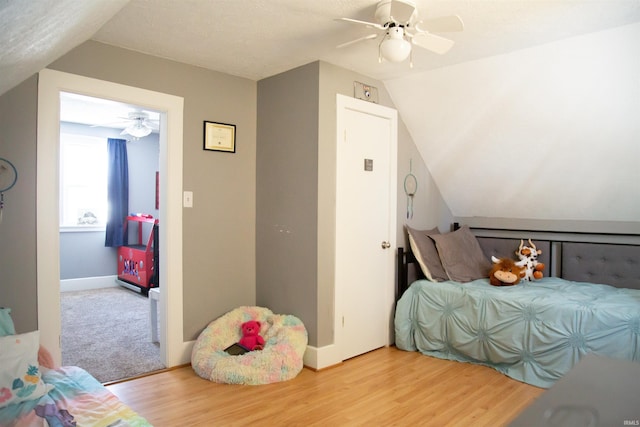 bedroom featuring vaulted ceiling, ceiling fan, and wood-type flooring