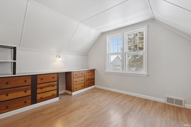 bonus room featuring lofted ceiling and light wood-type flooring