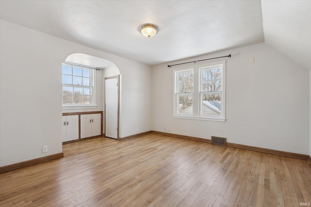 bonus room with lofted ceiling and light hardwood / wood-style floors