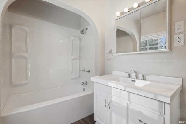 bathroom with tub / shower combination, hardwood / wood-style flooring, and vanity