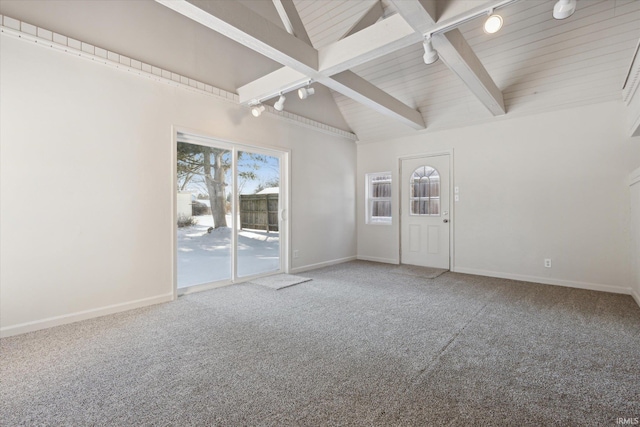 unfurnished room with wooden ceiling, carpet flooring, track lighting, and vaulted ceiling with beams