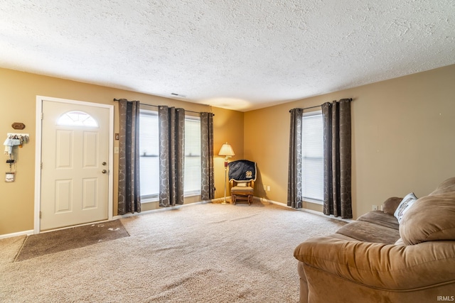 living room with carpet floors and a textured ceiling