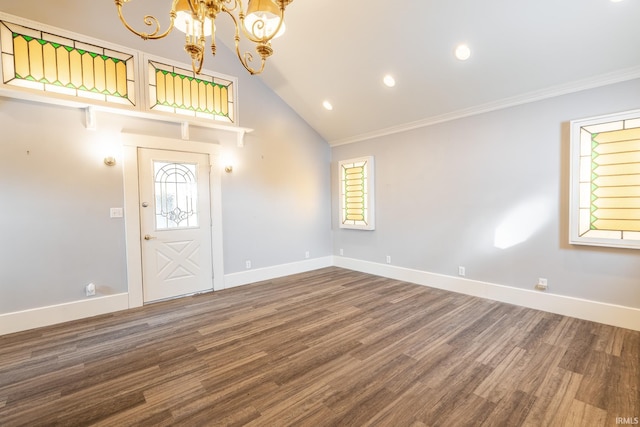 entrance foyer featuring hardwood / wood-style flooring, crown molding, lofted ceiling, and an inviting chandelier