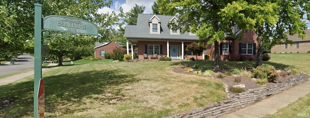 cape cod-style house with a porch and a front yard