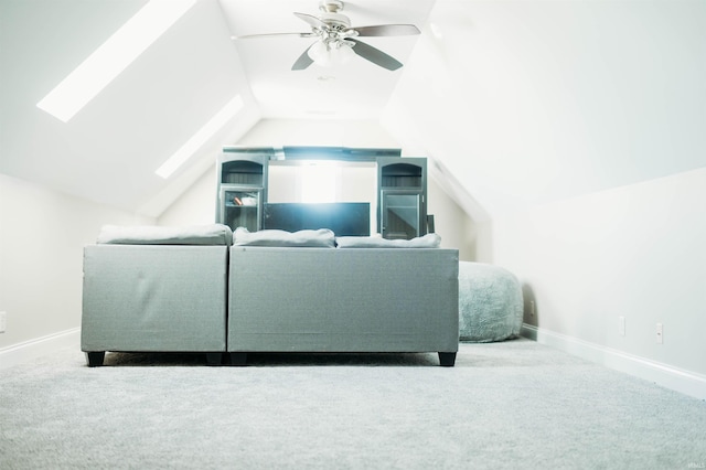 living room with carpet floors, lofted ceiling with skylight, and ceiling fan