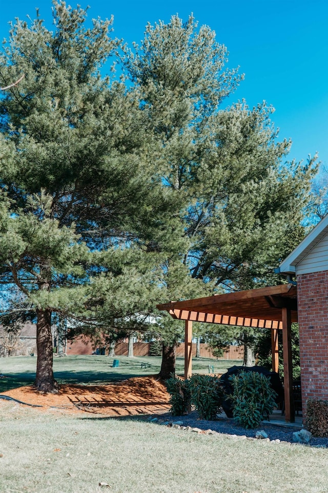 view of home's community featuring a pergola and a lawn