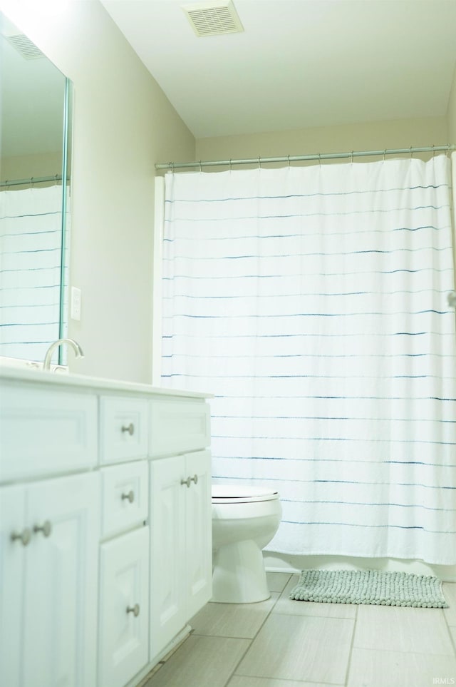 bathroom featuring tile patterned floors, toilet, and vanity