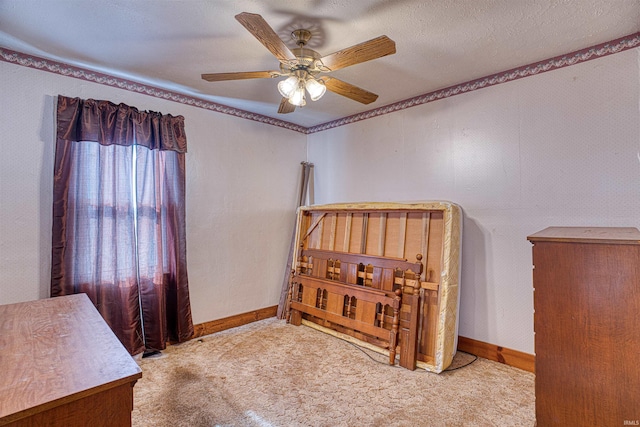 carpeted bedroom featuring a textured ceiling and ceiling fan