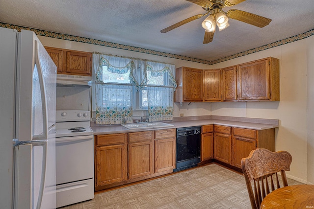 kitchen featuring sink, white appliances, and a textured ceiling