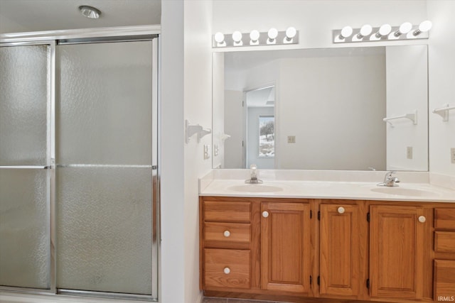 bathroom featuring walk in shower and vanity