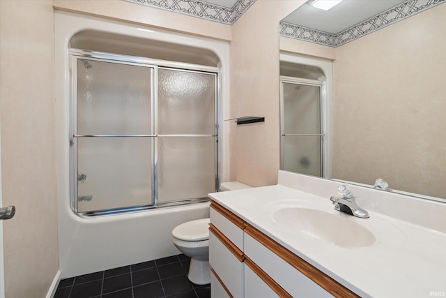 full bathroom with toilet, vanity, tile patterned floors, and combined bath / shower with glass door