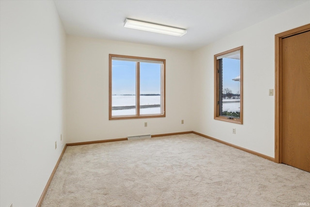 unfurnished room with light carpet