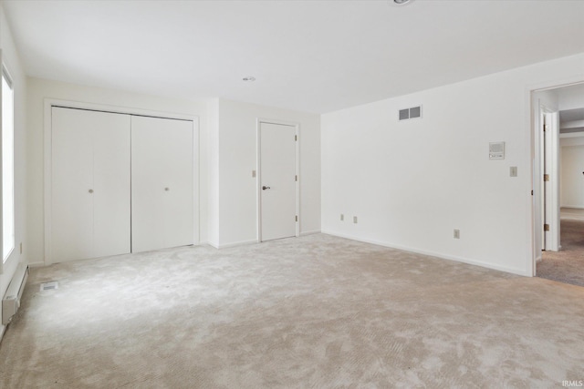 unfurnished bedroom featuring light carpet