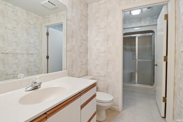 bathroom featuring an enclosed shower, vanity, and toilet