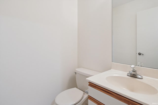 bathroom featuring toilet and vanity