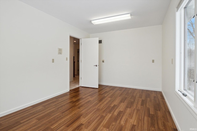 empty room with dark wood-type flooring