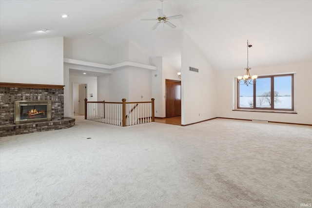 unfurnished living room featuring light carpet, a brick fireplace, ceiling fan with notable chandelier, and high vaulted ceiling