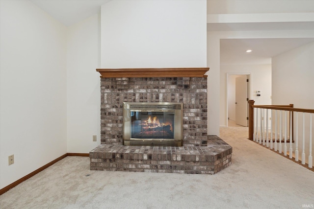 unfurnished living room with carpet flooring, lofted ceiling, and a fireplace